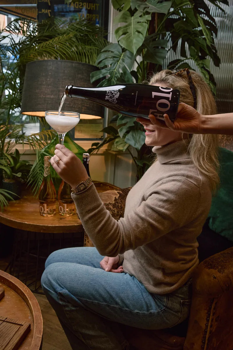 Folc sparkling rosé poured into a coupe in a café