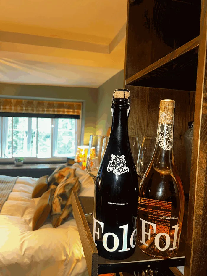 Folc sparkling rosé and Folc rosé on a shelf in a hotel room