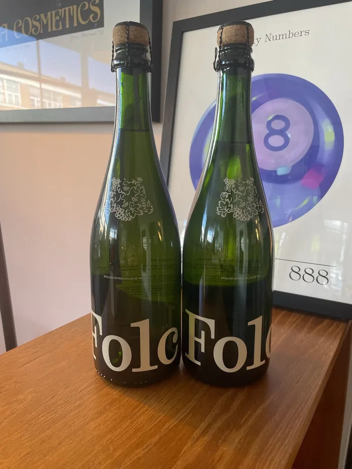 Two bottles of Folc sparkling rosé on a sideboard
