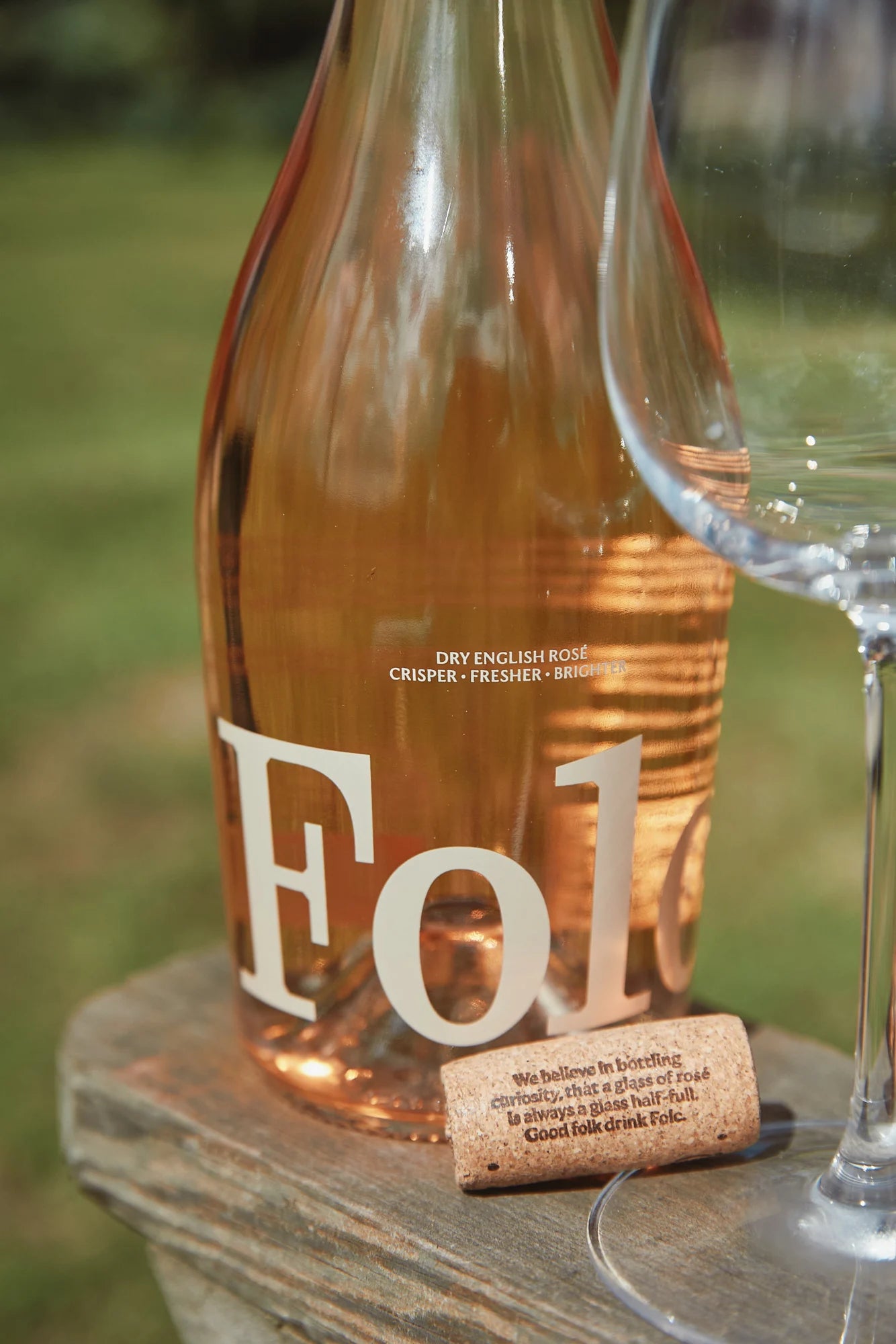 A bottle of Folc rosé with its cork and a glass