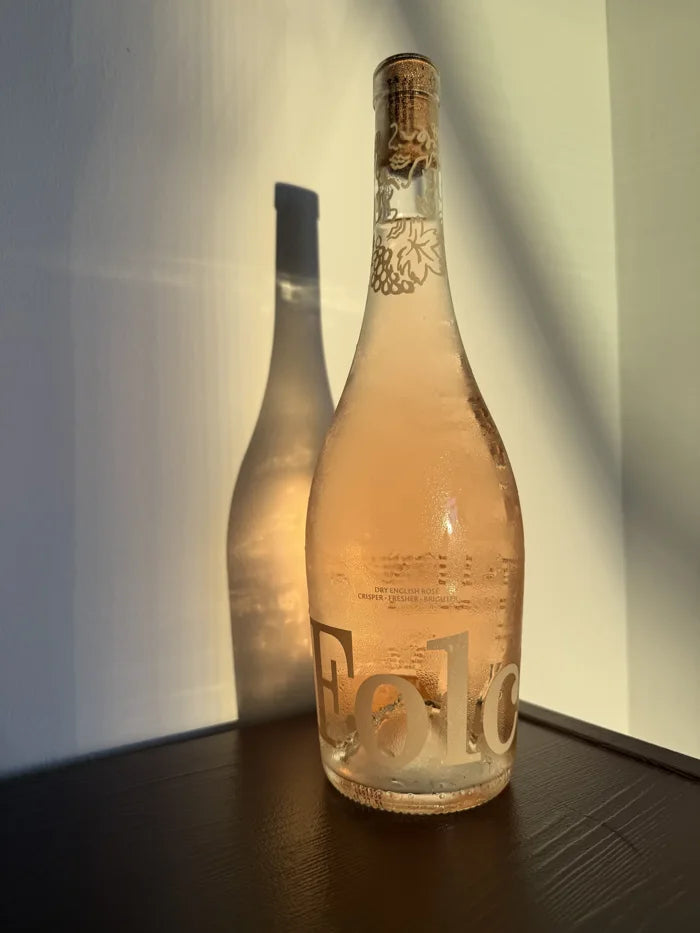 A bottle of Folc rosé in evening sun on a sideboard
