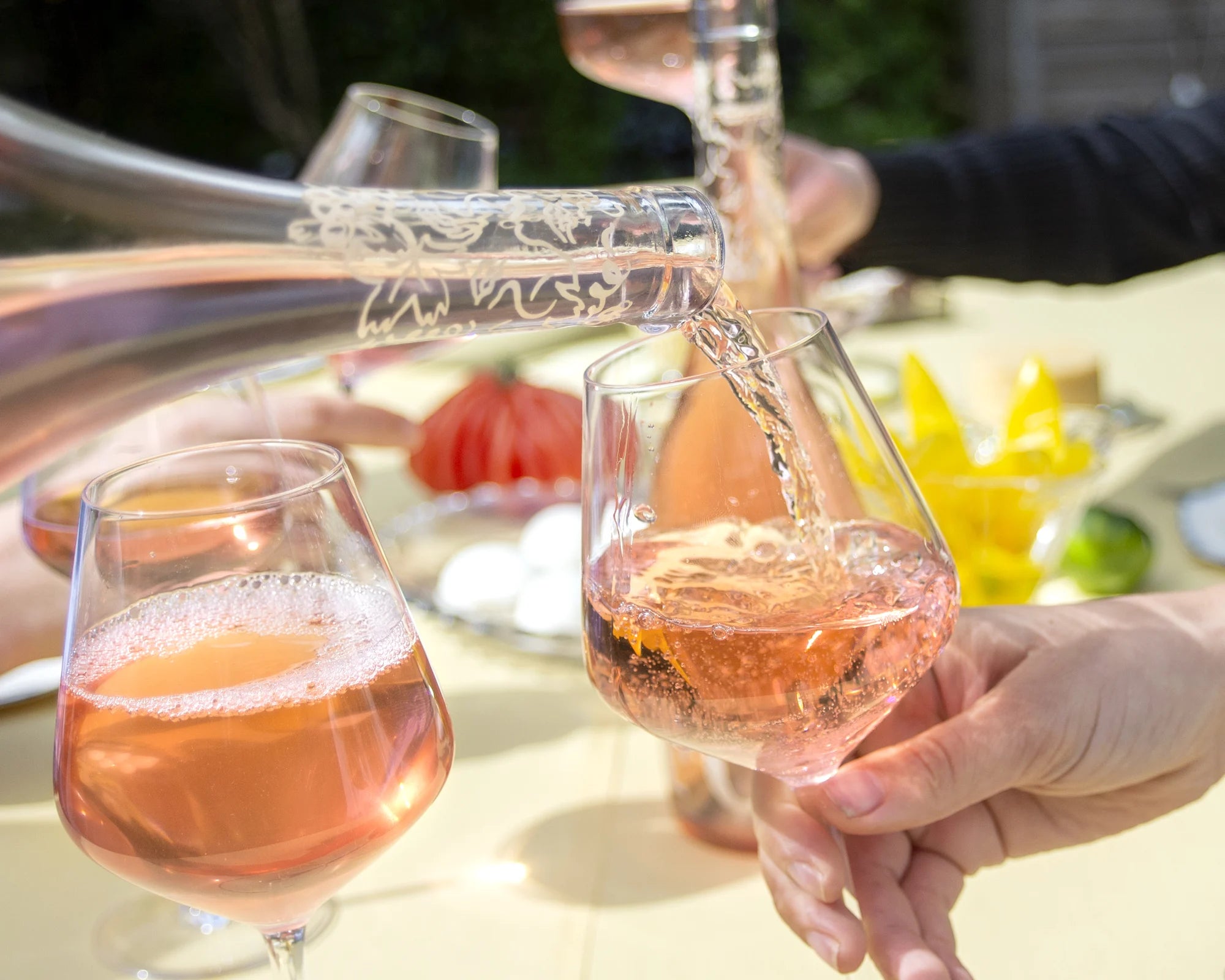 Folc rosé poured at a lunch table laid with food